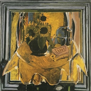 May include: A still life painting of sunflowers in a vase on a table with a book and a pitcher. The painting is framed in a dark wood frame.