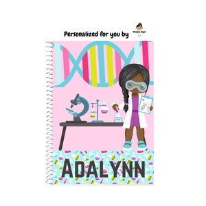 May include: A spiral-bound notebook with a pink cover featuring a cartoon scientist girl in a lab coat and glasses. The cover includes a DNA strand design and the name "ADALYNN" in large letters. A microscope and lab equipment are also shown.