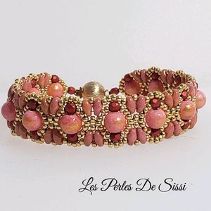 May include: A pink and gold beaded bracelet with a magnetic clasp. The bracelet features a repeating pattern of pink and gold beads.