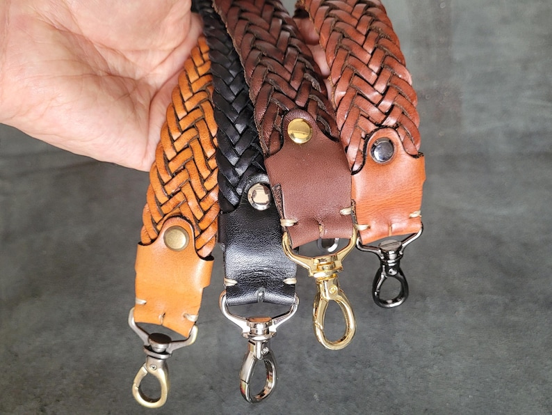 May include: Three braided leather straps with metal clasps. The straps are brown, black, and a lighter brown. The straps are woven together in a pattern.
