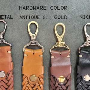 May include: Four leather straps with different colored metal clasps. The clasps are labeled "Gun Metal", "Antique G.", "Gold", and "Nickel".
