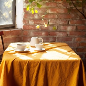 two cups of coffee sit on a table in front of a window