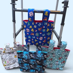 May include: Four fabric bags with two top handles each, designed to attach to a walker. One bag features a blue background with various cartoon characters, while the others display patterns including Harry Potter text, doodles, and holiday motifs.