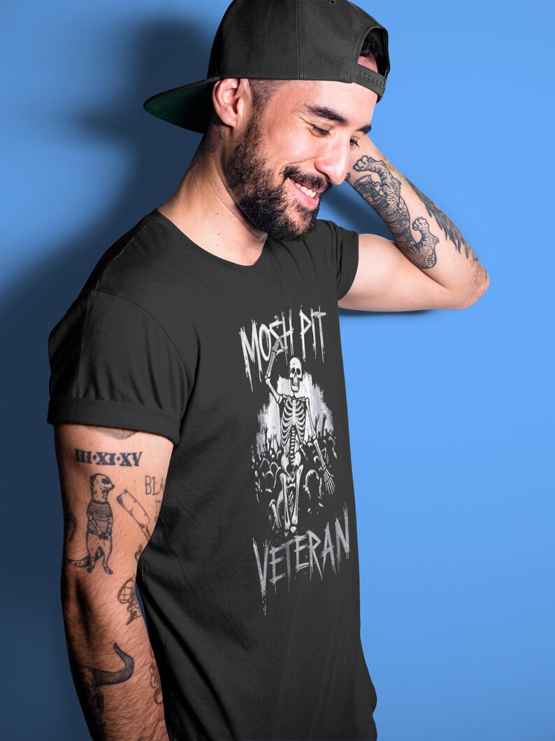 Unleash your rebel spirit with the Mosh Pit Veteran  Featuring a bold skeleton graphic, this edgy streetwear piece is perfect for punk rockers, skaters, and music lovers. Made from durable cotton, it's a must-have for non-conformists!