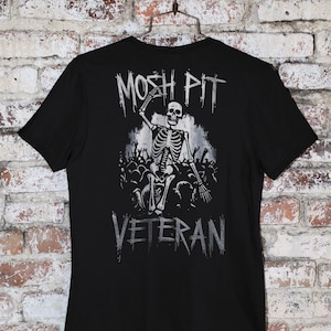 Unleash your rebel spirit with the Mosh Pit Veteran  Featuring a bold skeleton graphic, this edgy streetwear piece is perfect for punk rockers, skaters, and music lovers. Made from durable cotton, it's a must-have for non-conformists!