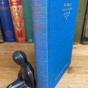 May include: A blue hardcover book titled "The Works of Jane Austen" with the words "Northanger Abbey" printed on the spine.