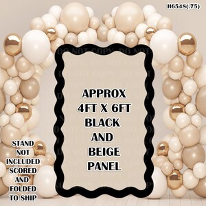 May include: A black and beige panel with the text "APPROX 4FT X 6FT BLACK AND BEIGE PANEL". The panel is surrounded by a balloon arch in shades of white, beige, and gold. The text "STAND NOT INCLUDED SCORED AND FOLDED TO SHIP" is also visible.