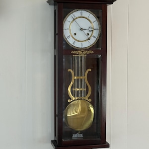 May include: A white ceramic mug with a black handle and the text "But First, Coffee" in a bold, black font. The mug is set against a blurred background, suggesting a cozy setting. The mug appears to be approximately 4 inches tall.