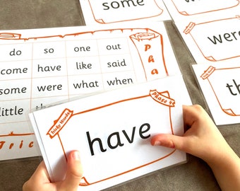 May include: A set of white flash cards with orange borders, featuring common sight words for early readers. The words include "do", "so", "one", "out", "come", "have", "like", "said", "some", "were", "what", "when", "little", "the", and "have".