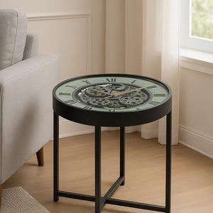 May include: Round black side table with a clock face design. The table features a black metal frame and a clock face with Roman numerals and visible gears. The clock face has a green background. The table is approximately 24 inches in diameter.