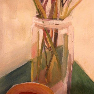 May include: A still life painting of a clear glass jar filled with dried stems and leaves. The jar sits on a green surface, with a partially visible orange object in the foreground. The background is a light beige color.