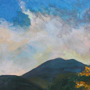 May include: An original watercolor painting of a mountain landscape. The sky is a mix of blue, white, and gray, with a hint of yellow. The mountain is dark blue-green, and the foreground features green foliage with orange accents.