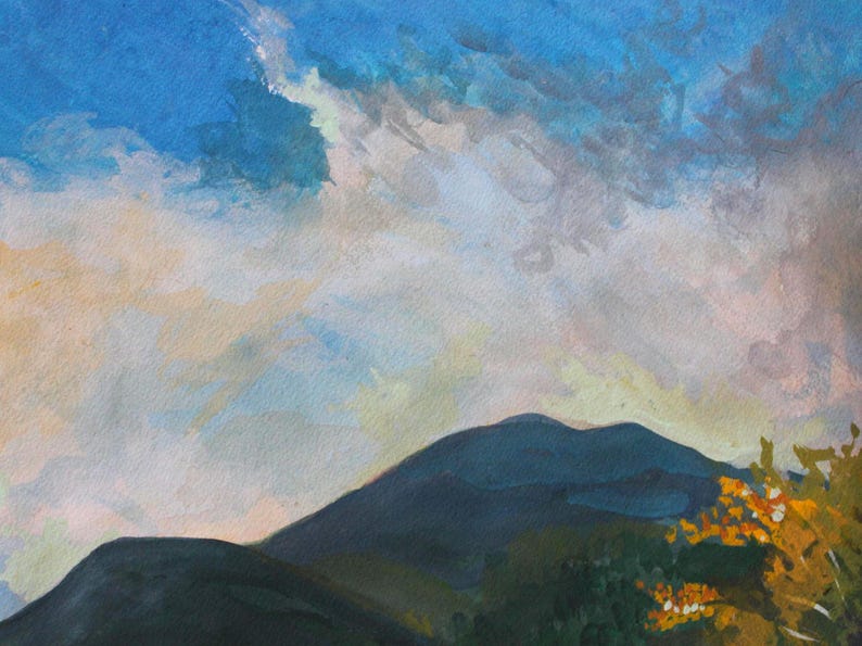 May include: An original watercolor painting of a mountain landscape. The sky is a mix of blue, white, and gray, with a hint of yellow. The mountain is dark blue-green, and the foreground features green foliage with orange accents.