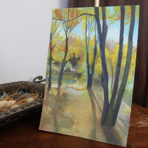 May include: Watercolor painting of a forest scene with tall trees and yellow leaves. The trees are painted in shades of blue and green, and the leaves are a bright yellow. The background is a soft blue.