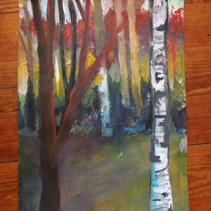 May include: An original painting of a forest scene. The artwork features a variety of trees with colorful foliage in shades of red, yellow, and green. The painting is on a rectangular canvas and is set against a wooden background.