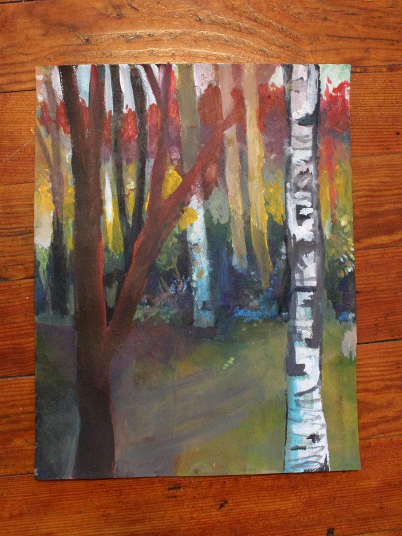 May include: An original painting of a forest scene. The artwork features a variety of trees with colorful foliage in shades of red, yellow, and green. The painting is on a rectangular canvas and is set against a wooden background.