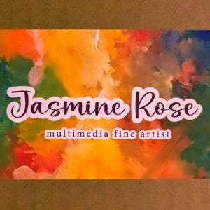 May include: A rectangular business card featuring a vibrant, abstract watercolor background with blended hues of orange, yellow, green, and blue. The text Jasmine Rose is printed in a dark purple script font, with multimedia fine artist below.