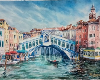 May include: A watercolor painting of a bridge over a canal in Venice, Italy. The bridge is white with blue accents and has many arches. There are buildings on both sides of the canal, and boats are in the water.