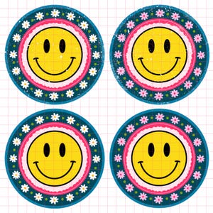May include: Four round, colorful stickers with a smiling yellow face in the center. Each sticker has a pink, white, and blue border with a white daisy pattern.