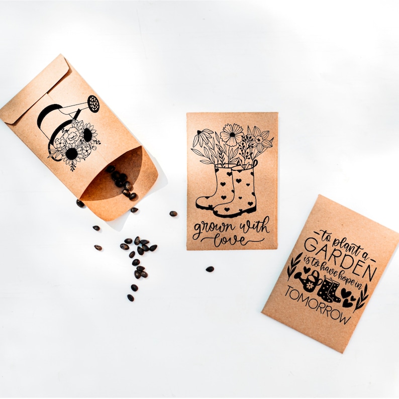 May include: Two brown paper seed packets with black ink illustrations and text. One packet shows a pair of rain boots with flowers growing out of them and the text "grown with love". The other packet shows a watering can with flowers and the text "to plant a garden is to have hope in tomorrow".