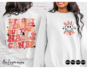 May include: White sweatshirt with a retro-style design. The back of the sweatshirt says "Life isn't perfect but your nails can be" with a nail polish bottle graphic. The front of the sweatshirt says "Nail Tech" with a smiley face graphic.