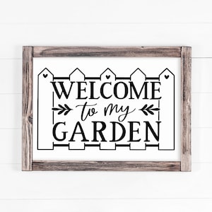 May include: Black and white sign with a picket fence design and the text "Welcome to my Garden".