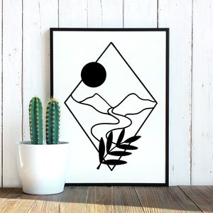 May include: Black framed art print with a minimalist landscape design. The print features mountains, a river, and a sun. A black and white botanical illustration is in the lower right corner. Two cacti in a white pot are to the left.