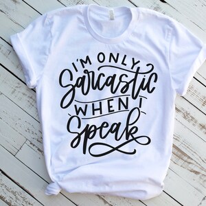 May include: White t-shirt with black text that reads "I'm only sarcastic when I speak".