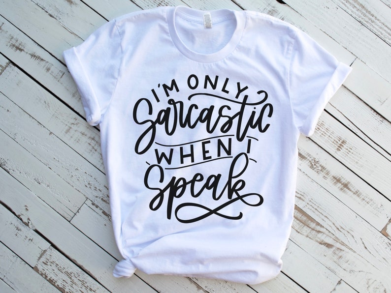 May include: White t-shirt with black text that reads "I'm only sarcastic when I speak".