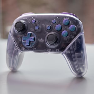 Nintendo Switch “Purple Reign” Pro-Controller Custom Clear Shells With Iridescent Purple And Blue Buttons