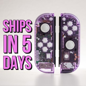 May include: A pair of purple and clear Nintendo Switch Joy-Con controllers with a galaxy and star design. The text "SHIPS IN 5 DAYS" is visible in the image.