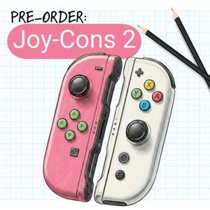 May include: Illustration of two Joy-Cons 2 controllers, one pink and one white, with black buttons and colored action buttons. The text "PRE-ORDER: Joy-Cons 2" is in a pink oval above the controllers. Two pencils are in the background.