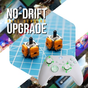 May include: Two small orange and silver hall effect joystick replacements for a video game controller. The text "NO-DRIFT HALL SENSING UPGRADE" is in the top left corner of the image. A white video game controller with green buttons is in the bottom right corner of the image.