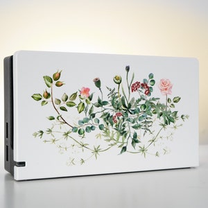 May include: White Nintendo Switch console skin with a watercolor floral design featuring pink roses, green leaves, and red berries.