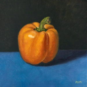 May include: A single orange bell pepper sits on a blue surface. The pepper is in focus, while the background is blurred.