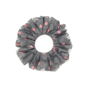 May include: Gray hair scrunchie with pink polka dots. The scrunchie is made of a soft, stretchy fabric and is perfect for holding hair in place.