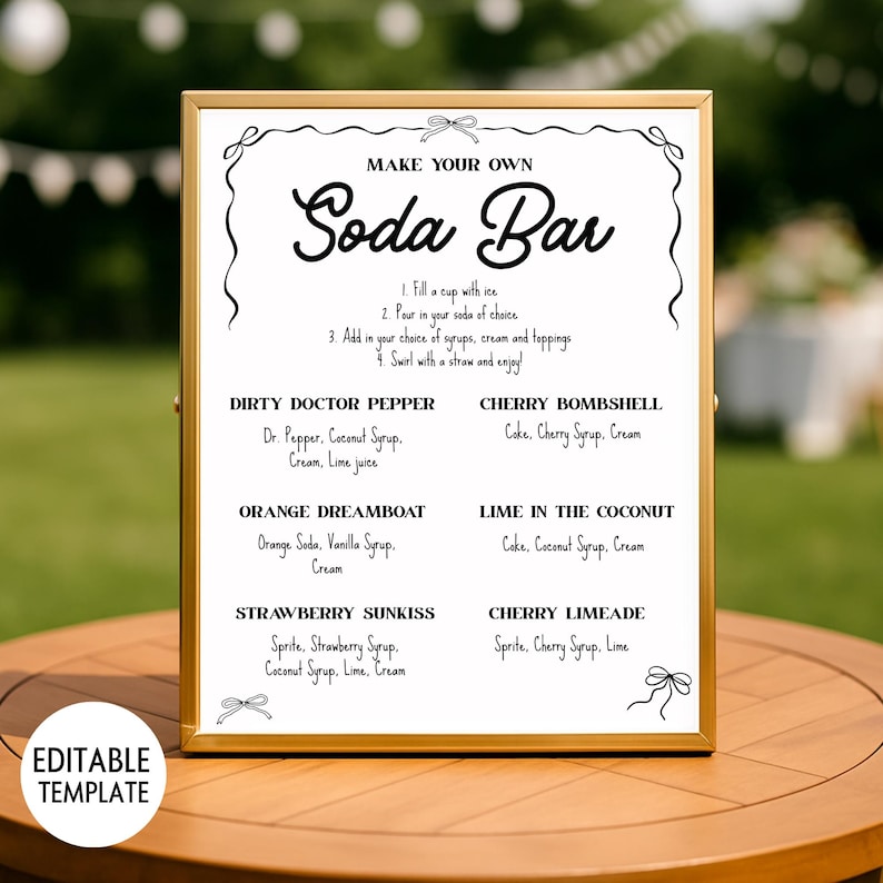 May include: A framed sign with the text "MAKE YOUR OWN Soda Bar" in black script. The sign lists instructions and soda flavor combinations like "Dirty Doctor Pepper" and "Cherry Bombshell". The sign is a wedding or party decoration.