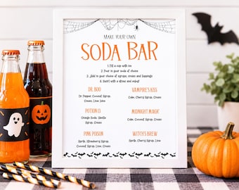 May include: A white framed sign titled Make Your Own Soda Bar with Halloween themed instructions and drink recipes including Dr. Boo, Vampire's Kiss, Potion 13, Midnight Magic, Pink Poison, and Witch's Brew, decorated with spiderwebs and bats.