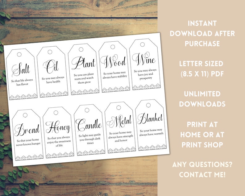 May include: Printable housewarming gift tags with a white background and black text. The tags feature a variety of items, such as salt, oil, plant, wood, wine, bread, honey, candle, metal, and blanket. Each tag includes a short phrase about the item and its significance for a new home.