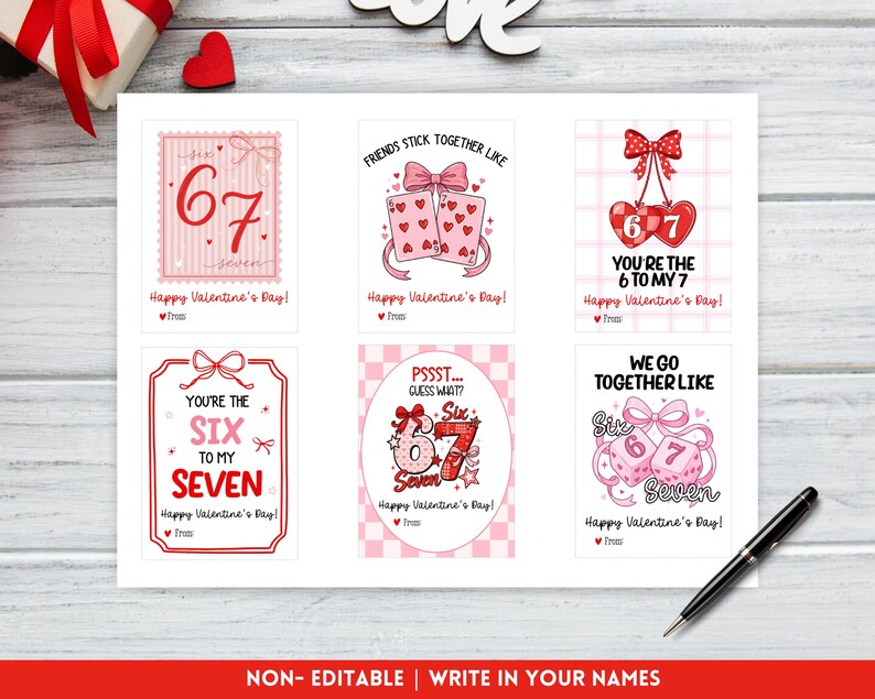 May include: A collection of six Valentine's Day cards with pink and red designs. Each card features the numbers 6 and 7, along with phrases like "You're the 6 to my 7" and "Friends stick together like". The cards are on a white surface.