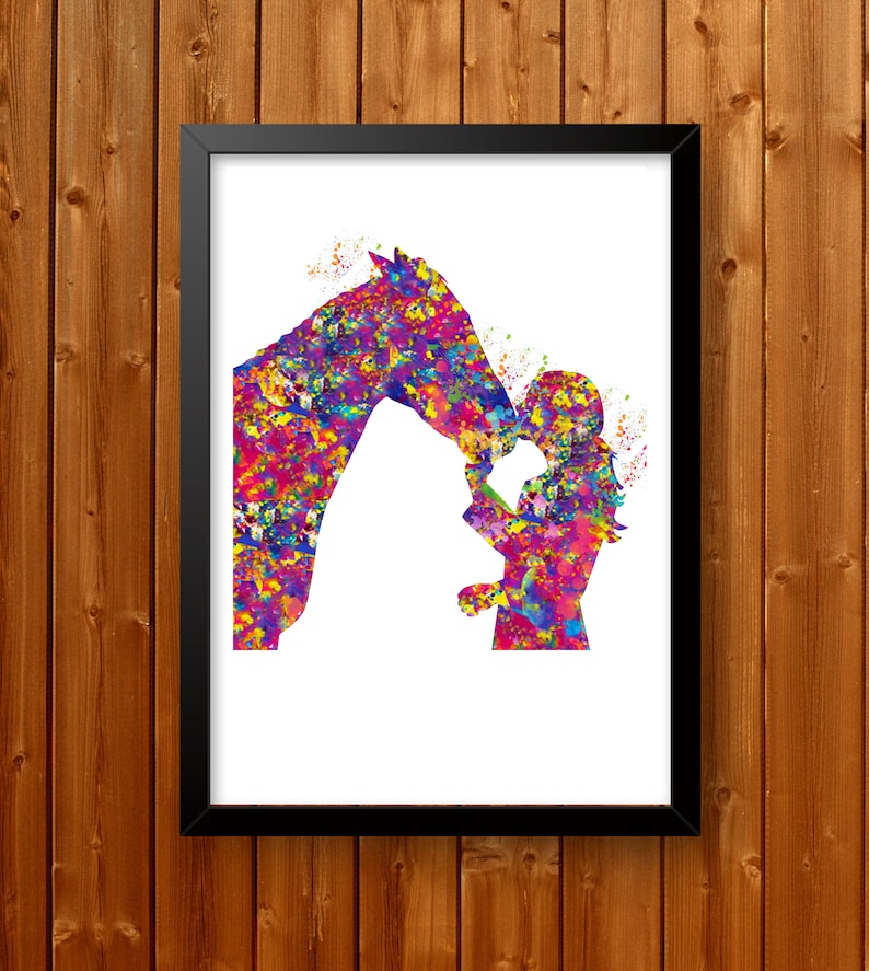 May include: A framed watercolour print depicting a horse and a person in an abstract style. The artwork uses a vibrant palette of pink, purple, blue, and yellow, creating a dynamic piece. The image is set against a white background. The frame is black.