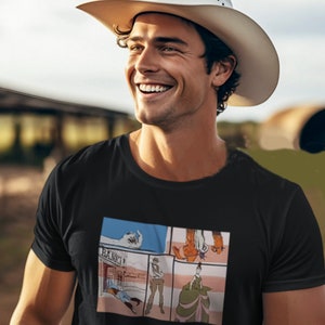 May include: A black t-shirt with a comic book style graphic print featuring a cowboy, a bank, and a woman in a long dress.
