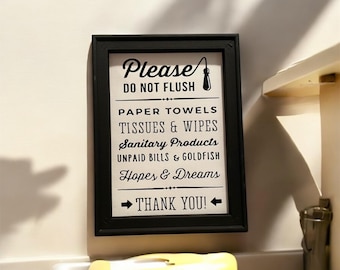 May include: A black framed sign with white text that reads "Please Do Not Flush Paper Towels Tissues & Wipes Sanitary Products Unpaid Bills & Goldfish Hopes & Dreams Thank You!"