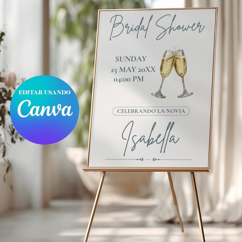 K&ouml;nnte beinhalten: Ein goldgerahmtes Schild auf einer goldenen Staffelei k&uuml;ndigt eine Brautparty an. Das Schild zeigt die Worte "Bridal Shower", Datum, Uhrzeit und den Namen "Isabella". Zwei Champagnergl&auml;ser sind abgebildet. Das Canva-Logo ist sichtbar.