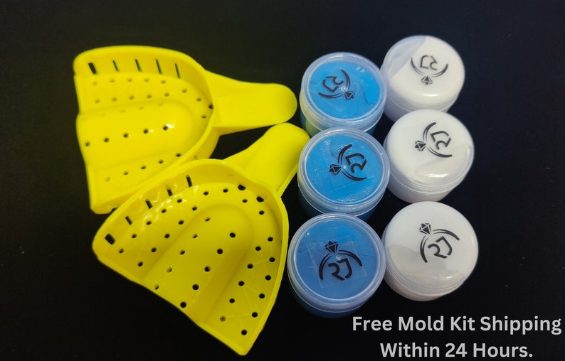 May include: Two yellow plastic dental impression trays with three small containers of blue and white dental impression material. The containers have a black diamond logo and the text "2J". The text "Free Mold Kit Shipping Within 24 Hours." is below the containers.