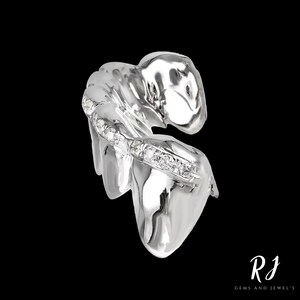 May include: Silver tooth grill with a row of diamonds set into the front. The grill is designed to fit over the front teeth.