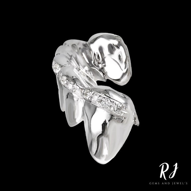 May include: Silver tooth grill with a row of diamonds set into the front. The grill is designed to fit over the front teeth.