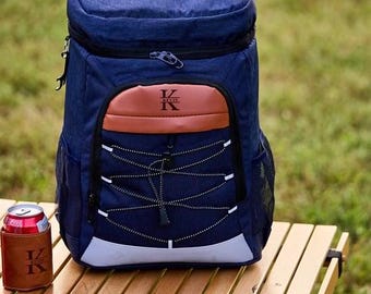 May include: A blue and brown insulated backpack with a zippered front pocket and a drawstring closure. The backpack has a white and blue strap with the letter "K" and the name "Kevin" on it.