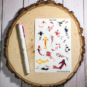 May include: A sheet of stickers featuring colorful koi fish illustrations. The stickers are on a white background and have the text "Koi Fish" at the top. The text "Sakura Design Gallery" is at the bottom of the sheet.