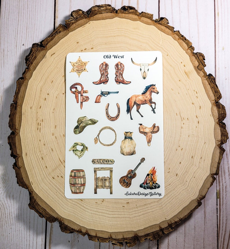 May include: A sheet of stickers with a western theme. The stickers feature images of cowboy boots, a sheriff's badge, a skull, a horse, a lasso, a saddle, a cowboy hat, a bandana, a saloon door, a guitar, and a campfire. The text "Old West" is at the top of the sheet.